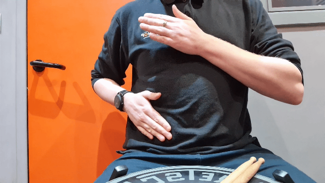 demonstration of how to tap your chest and stomach to make a drum beat